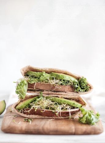 Freshly baked whole wheat pita pockets stuffed with vibrant greens and homemade hummus