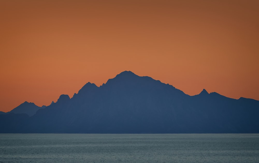 silhouette of mountain by the sea