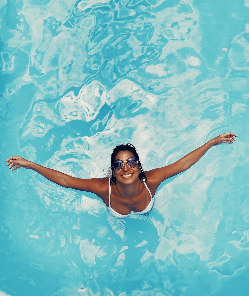 woman spreading her arms in body of water