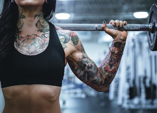 woman carrying barbell