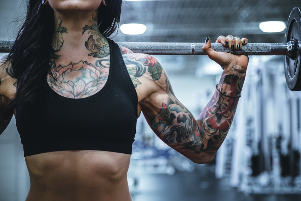 woman carrying barbell