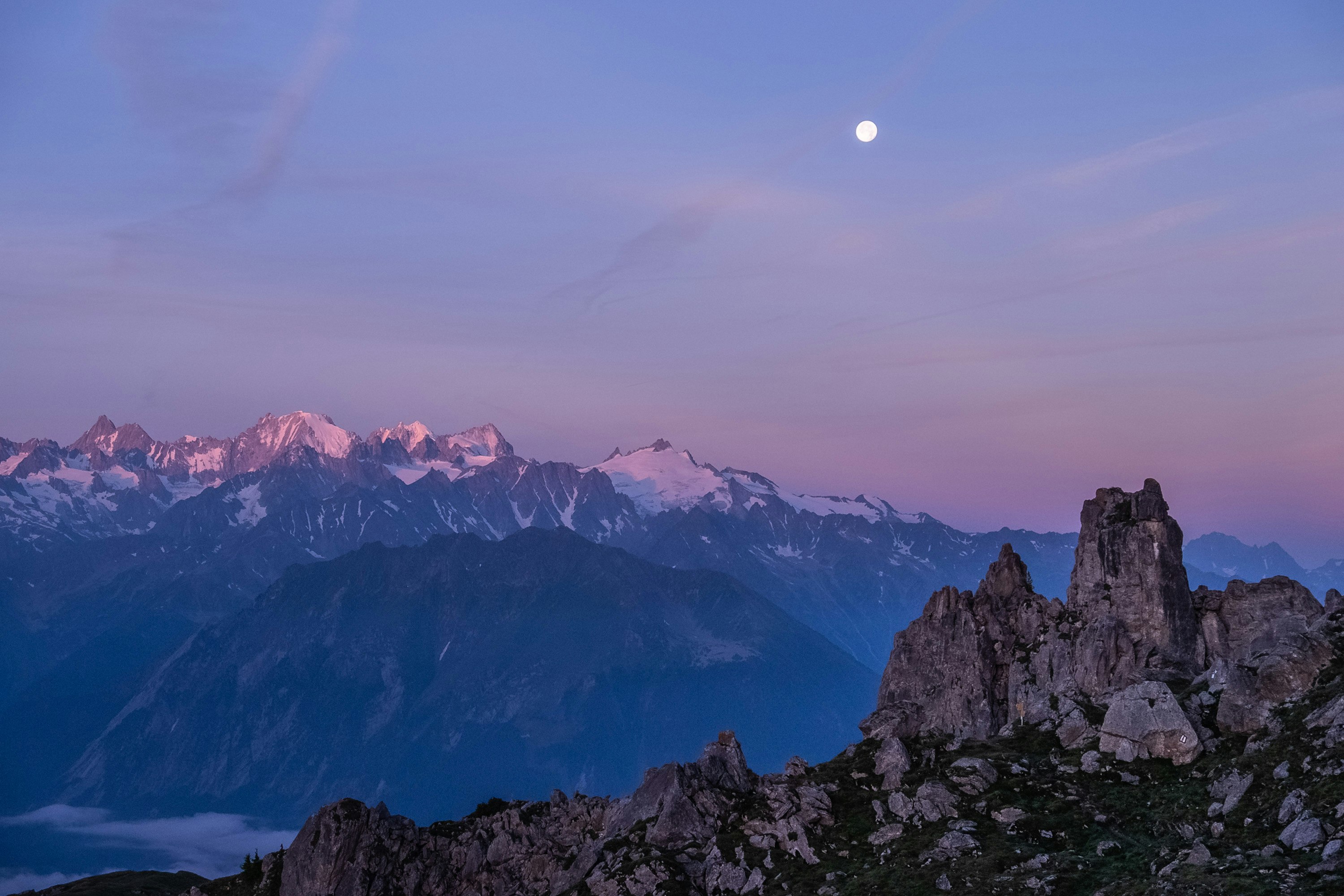 snow capped mountain under blue and gray skies