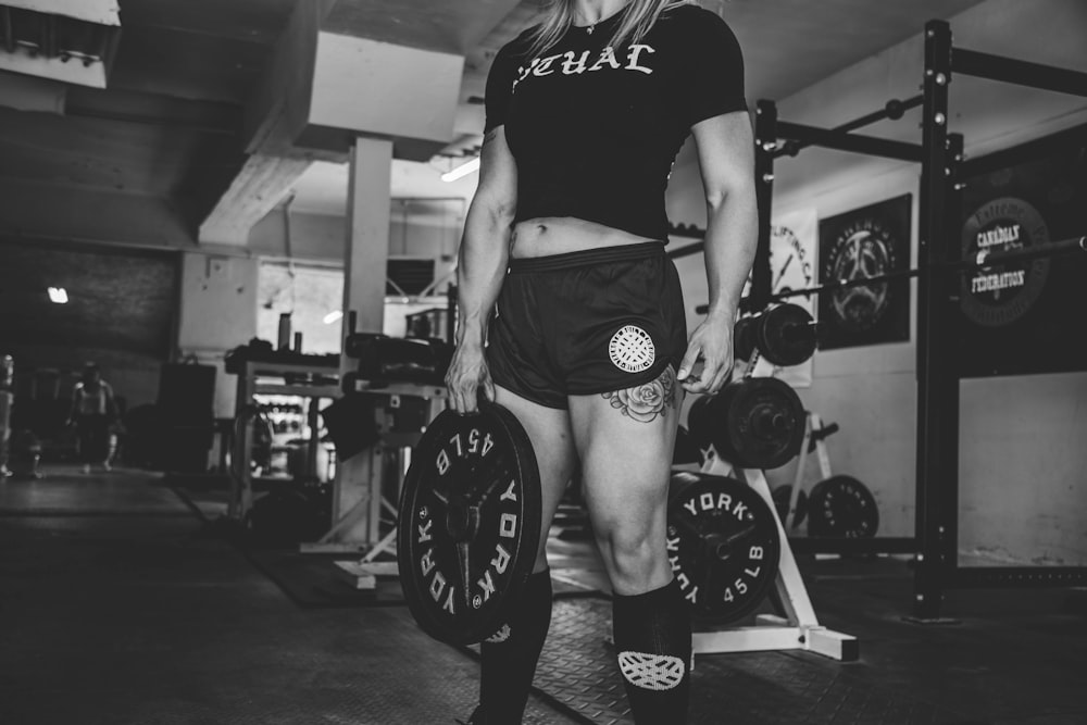 person holding barbell plate