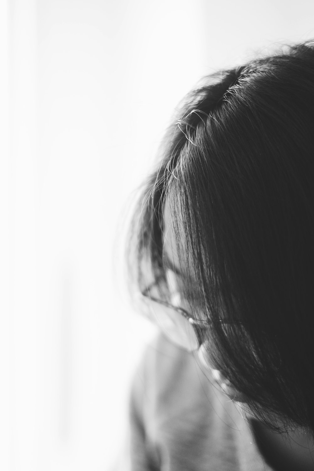 gray scale photography of person wearing eyeglasses