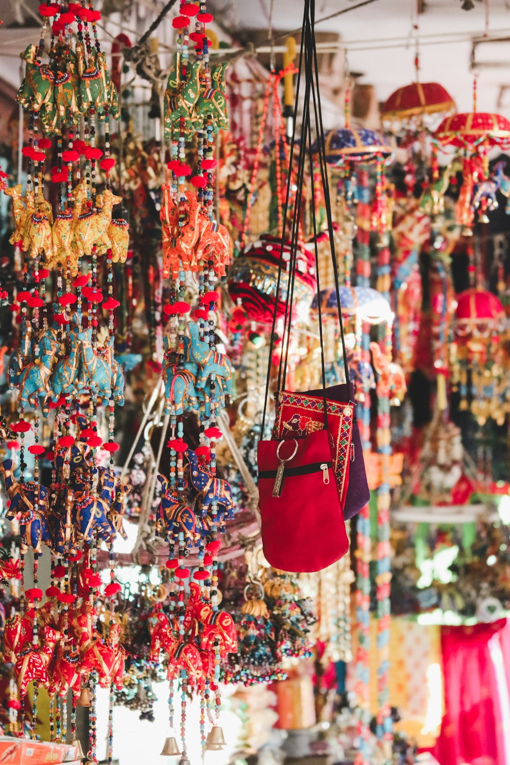 photo of red crossbody bag hanging beside ornaments