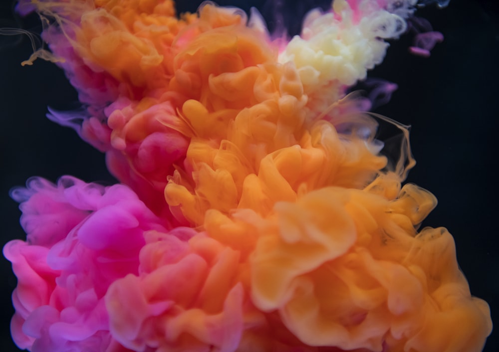shallow focus photography of pink and orange smoke