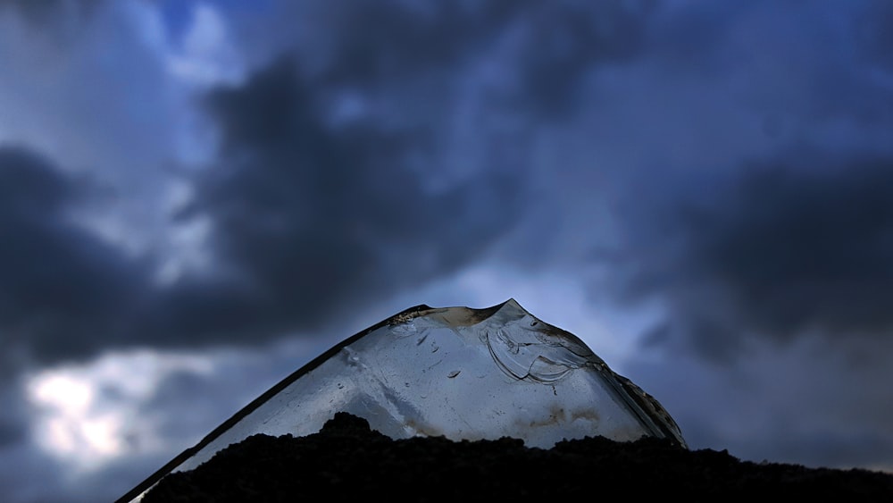 mountain covered by snow under cloudy sky