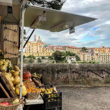 A vibrant farm stand bursting with colorful fresh vegetables and fruits under a sunny sky.