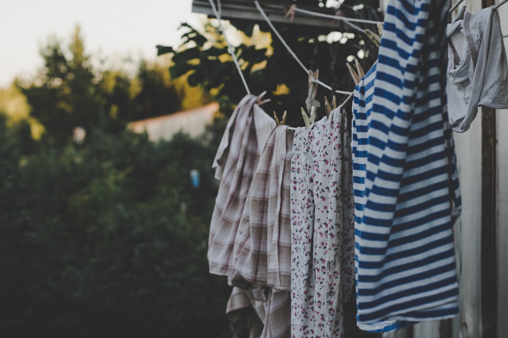 assorted-color clothes on hanged on rope during daytime