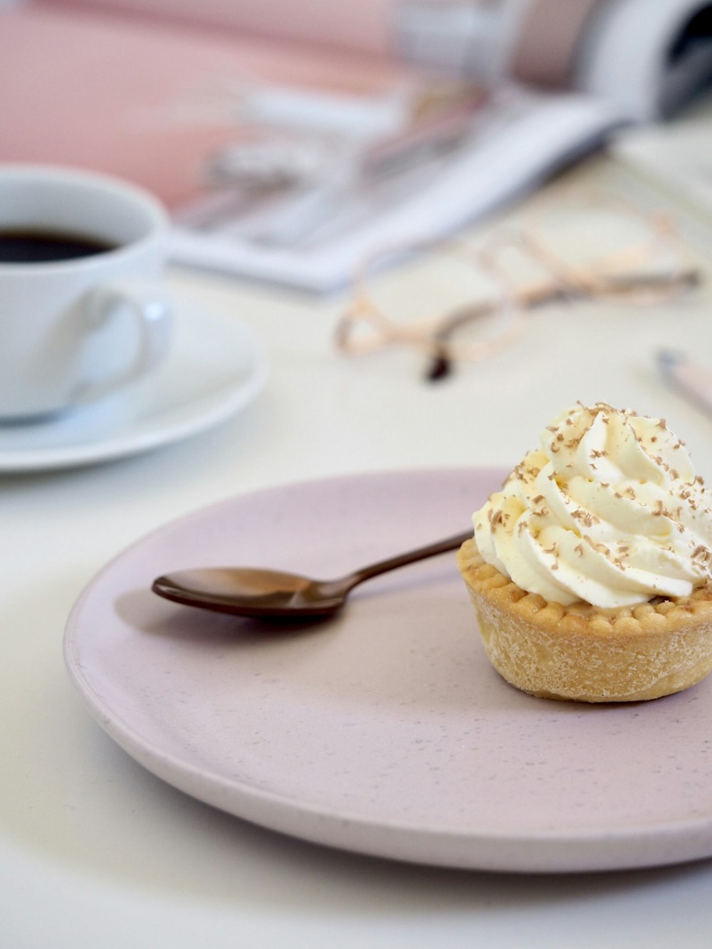 cupcake with white icing on white ceramic plate