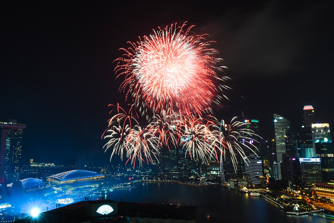 fireworks exploding on sky of Marina Bay Sands at nighttime