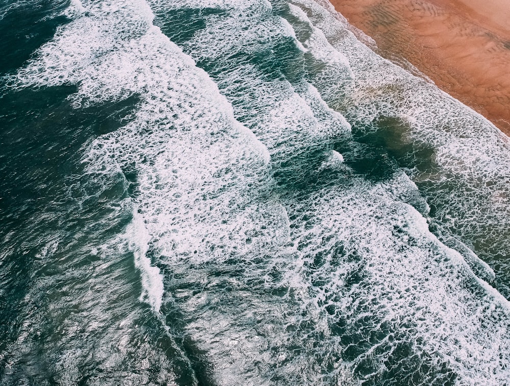 calm waves of sea on beach at daytime