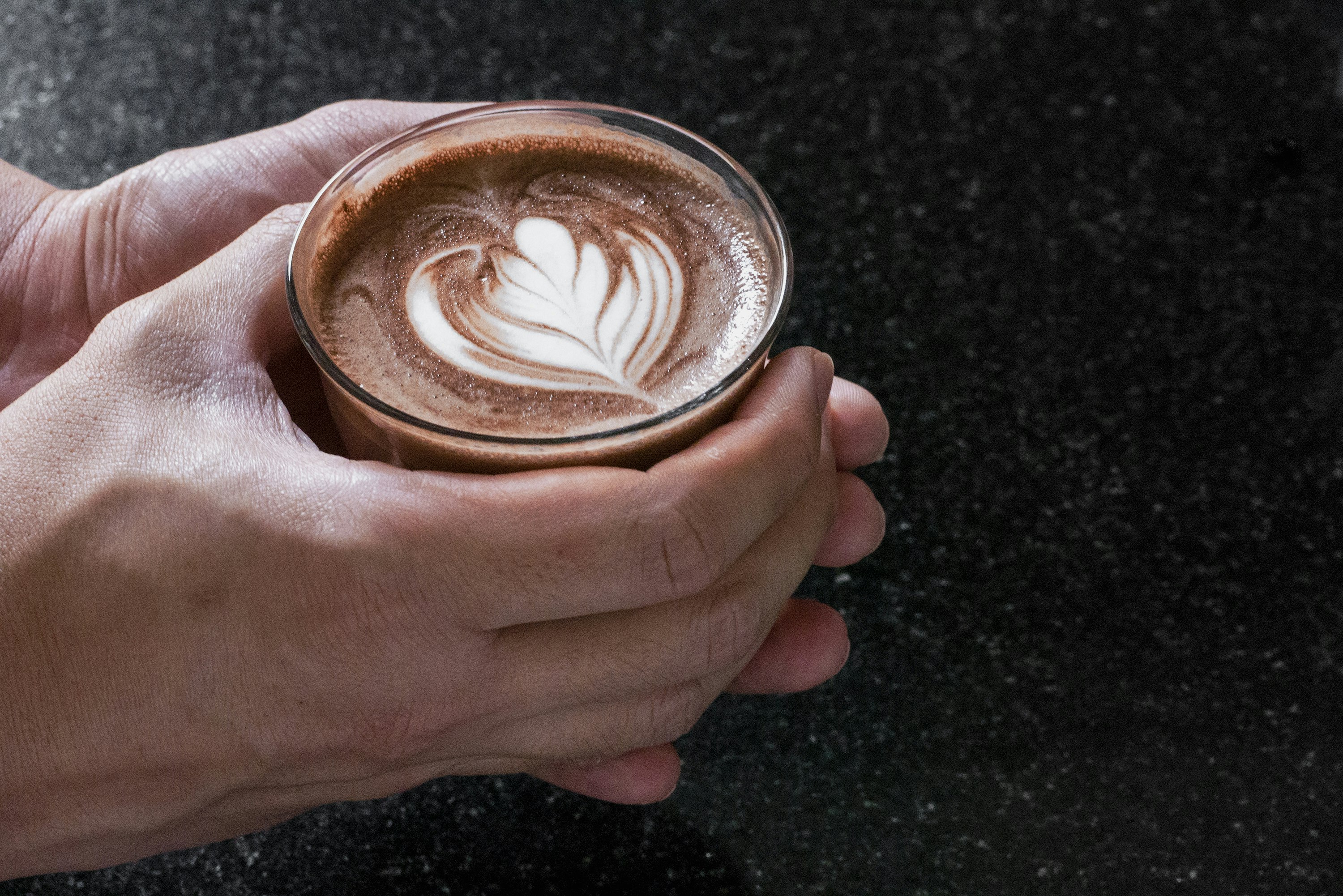 person holding glass cup