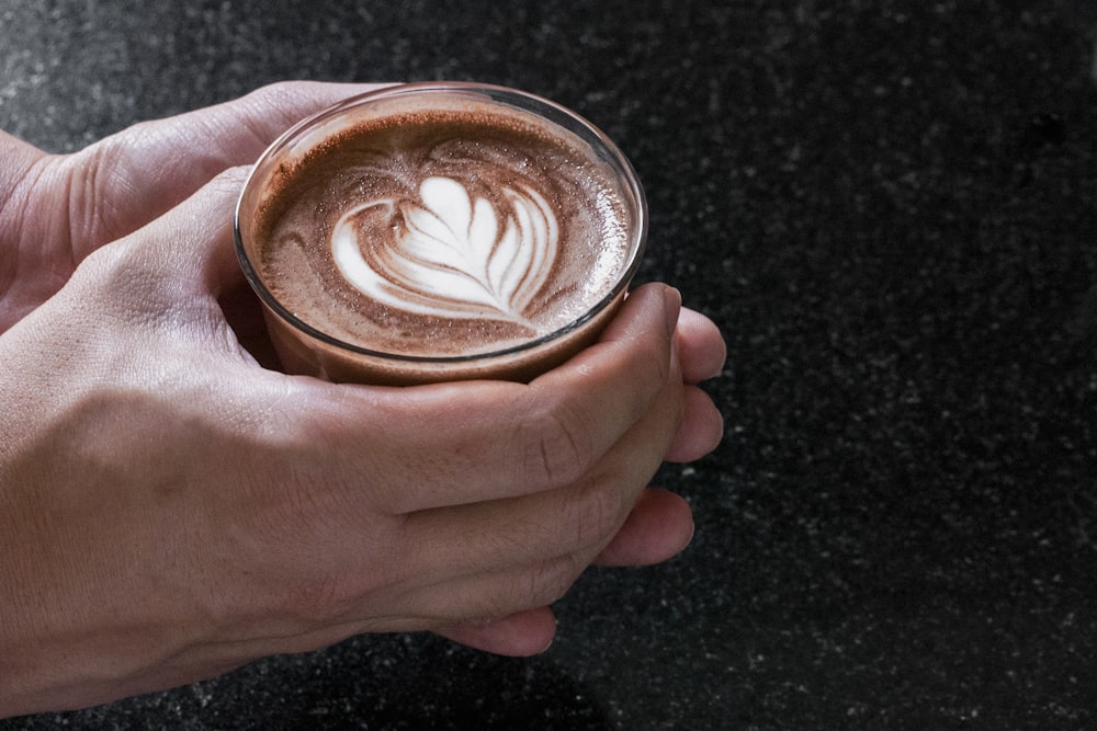 person holding glass cup