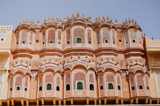 peach-colored mid-rise building low angle photography in Hawa Mahal India
