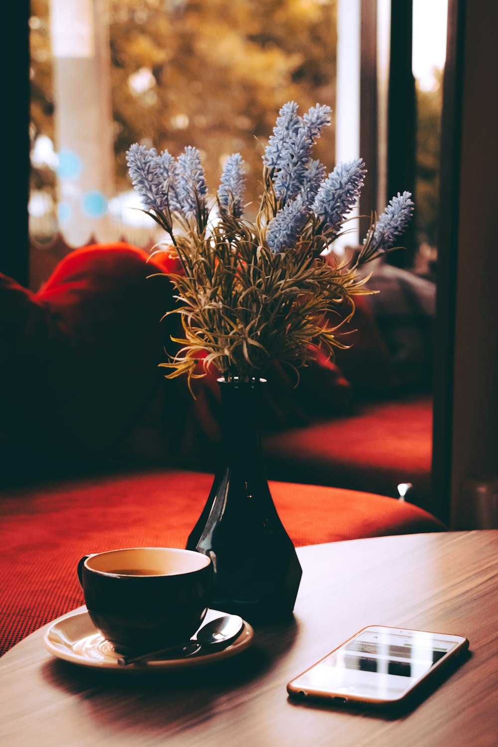 blue petaled flower on black ceramic vase