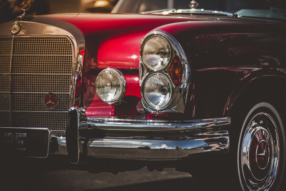close-up photo of classic red vehicle