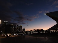 An artistic view of a city skyline at dusk with glowing lights.