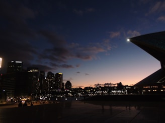 An artistic view of a city skyline at dusk with glowing lights.