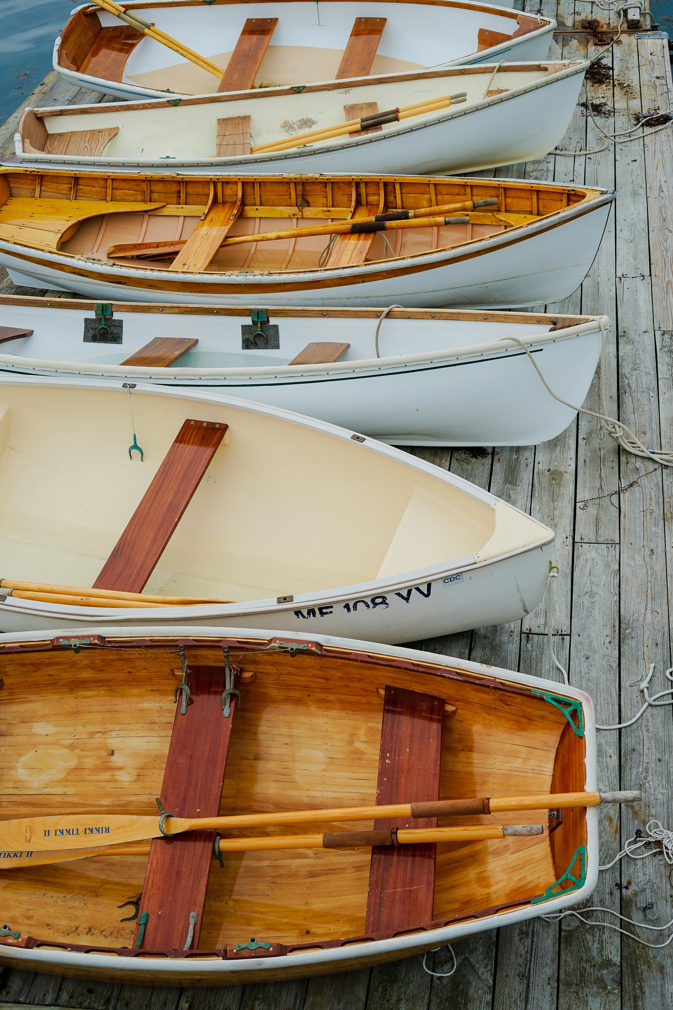 six brown-and-white woodn boats
