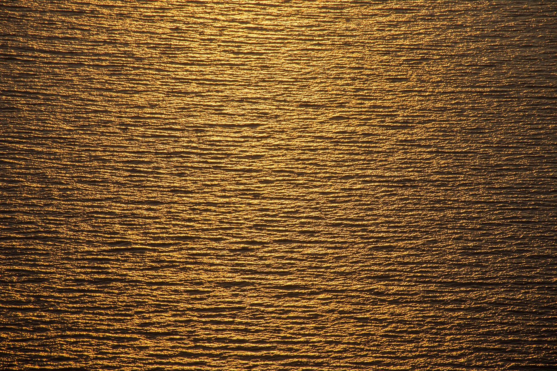 a large body of water with a boat in the distance