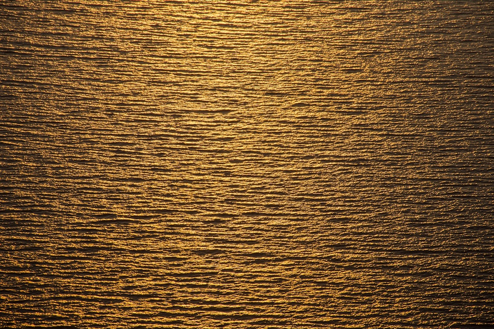 a large body of water with a boat in the distance