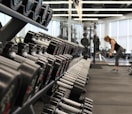 woman standing surrounded by exercise equipment