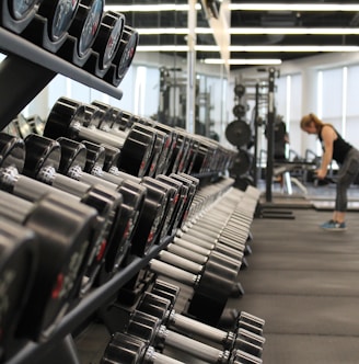 woman standing surrounded by exercise equipment