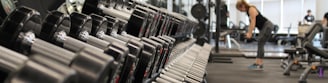 woman standing surrounded by exercise equipment