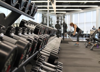 woman standing surrounded by exercise equipment