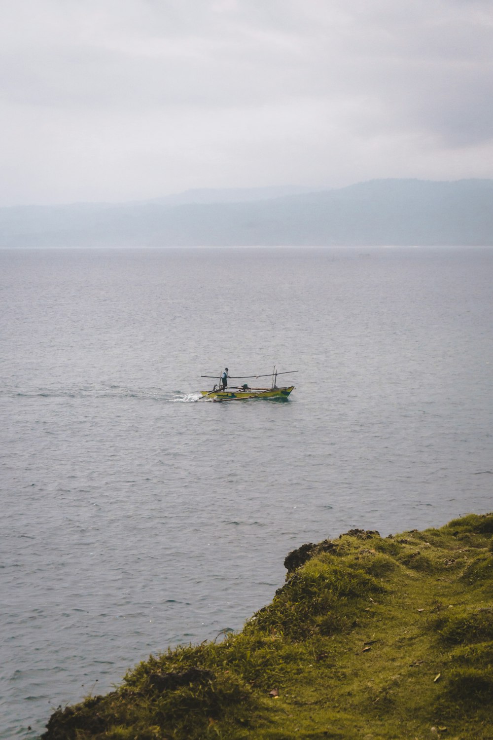 gray row boat on sea