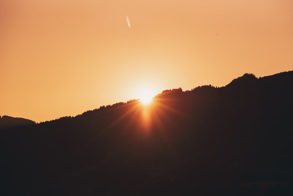 sun rays through mountain