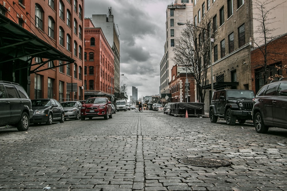 parked cars near buildings beside road