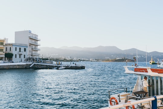 man riding on ship during daytime in Agios Nikolaos Greece