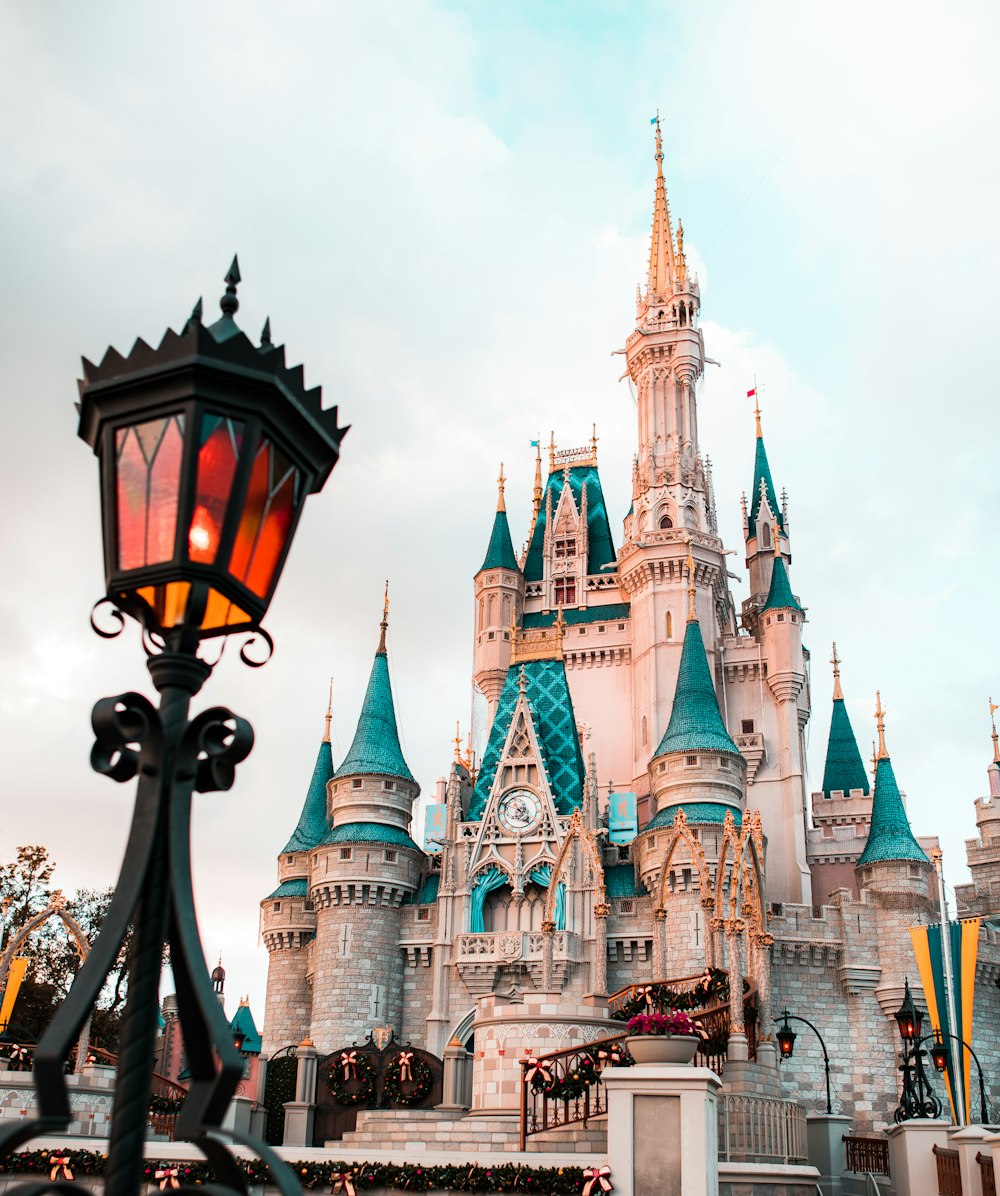 white and blue castle under cloudy sky during daytime