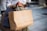 A happy customer holding shopping bags filled with various products.