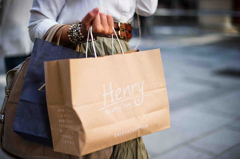 A shopper carrying retail bags