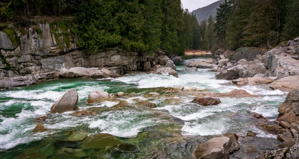 rock formation surrounded of body of water