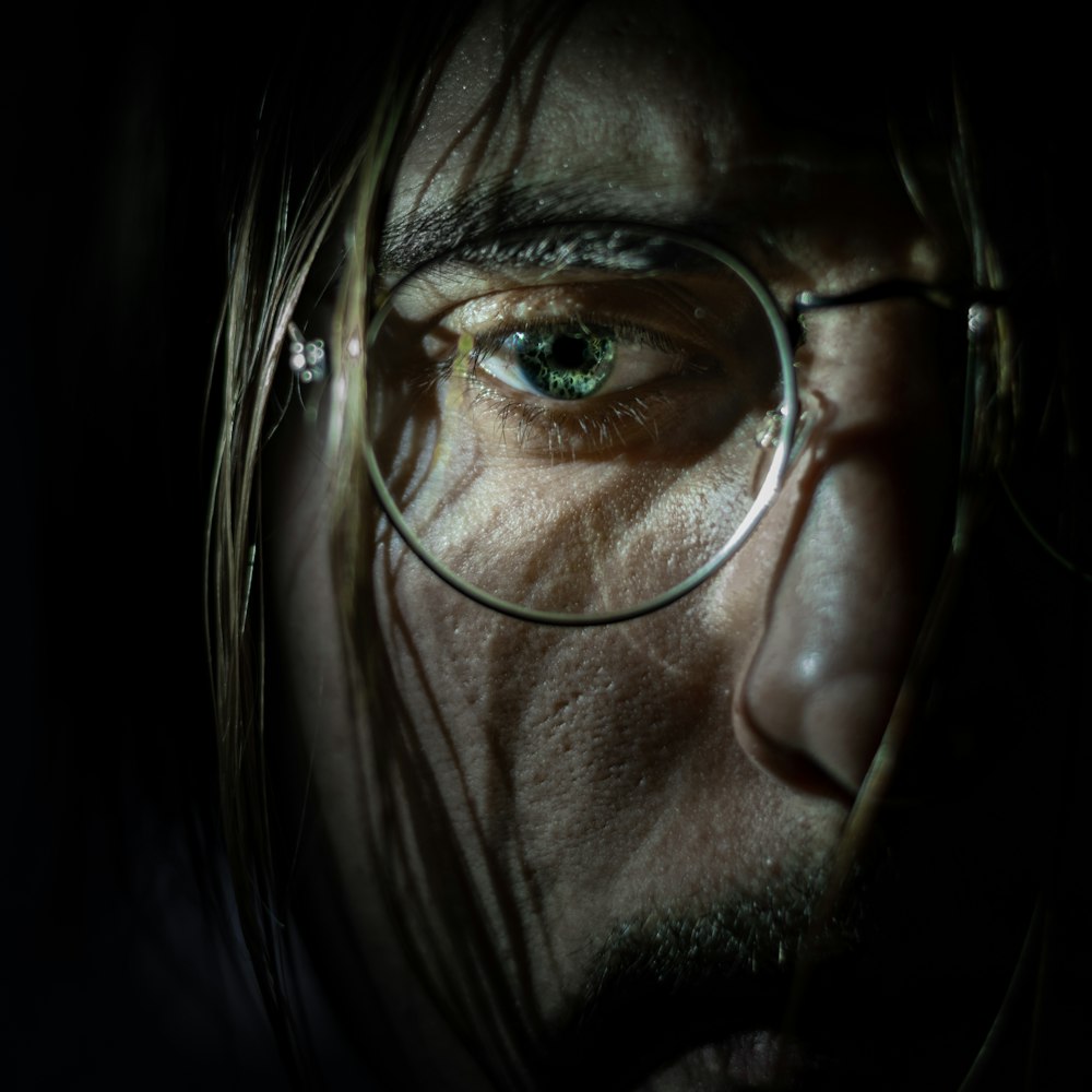a close up of a person wearing glasses