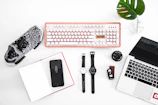 laptop computer beside analog watches on table