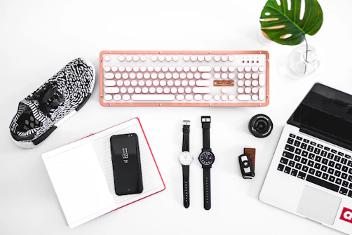 laptop computer beside analog watches on table