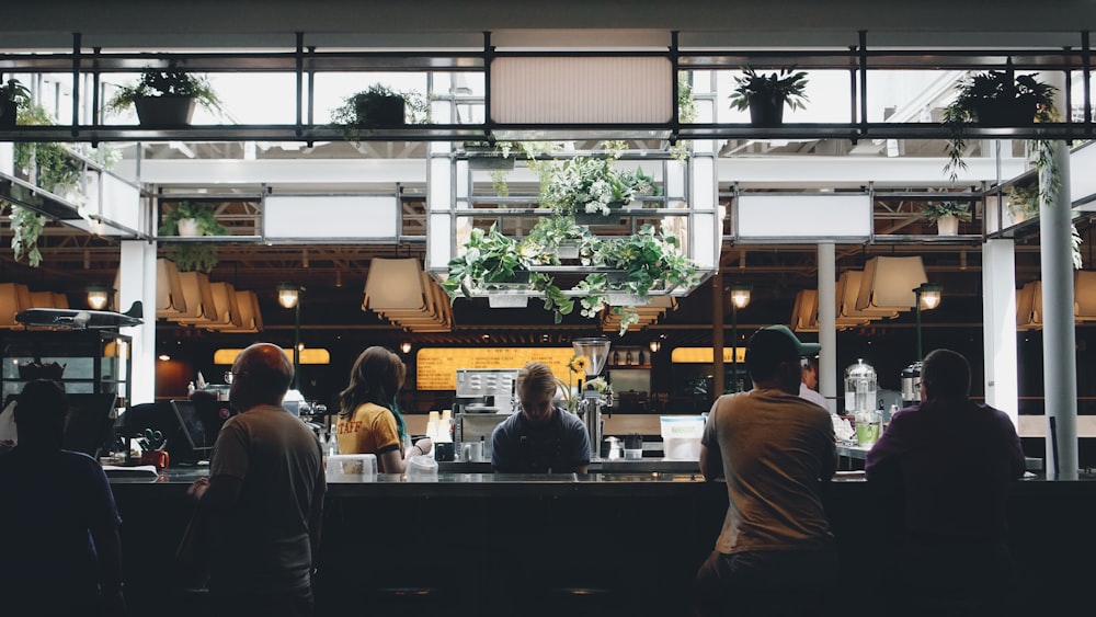 people sitting near stall