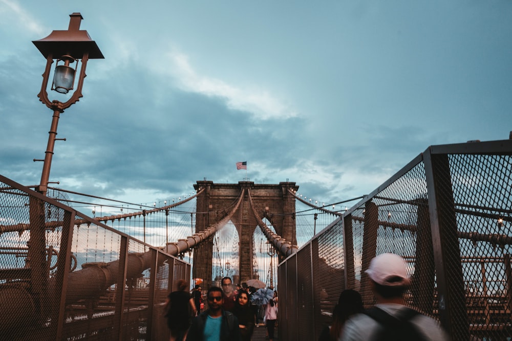 photo of people walking on Brooklyn Bridge
