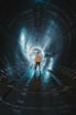 low light photography of man standing inside tunnel