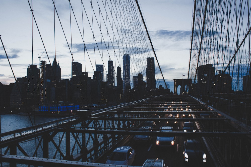 shallow focus photography of cars travelling on steel bridge