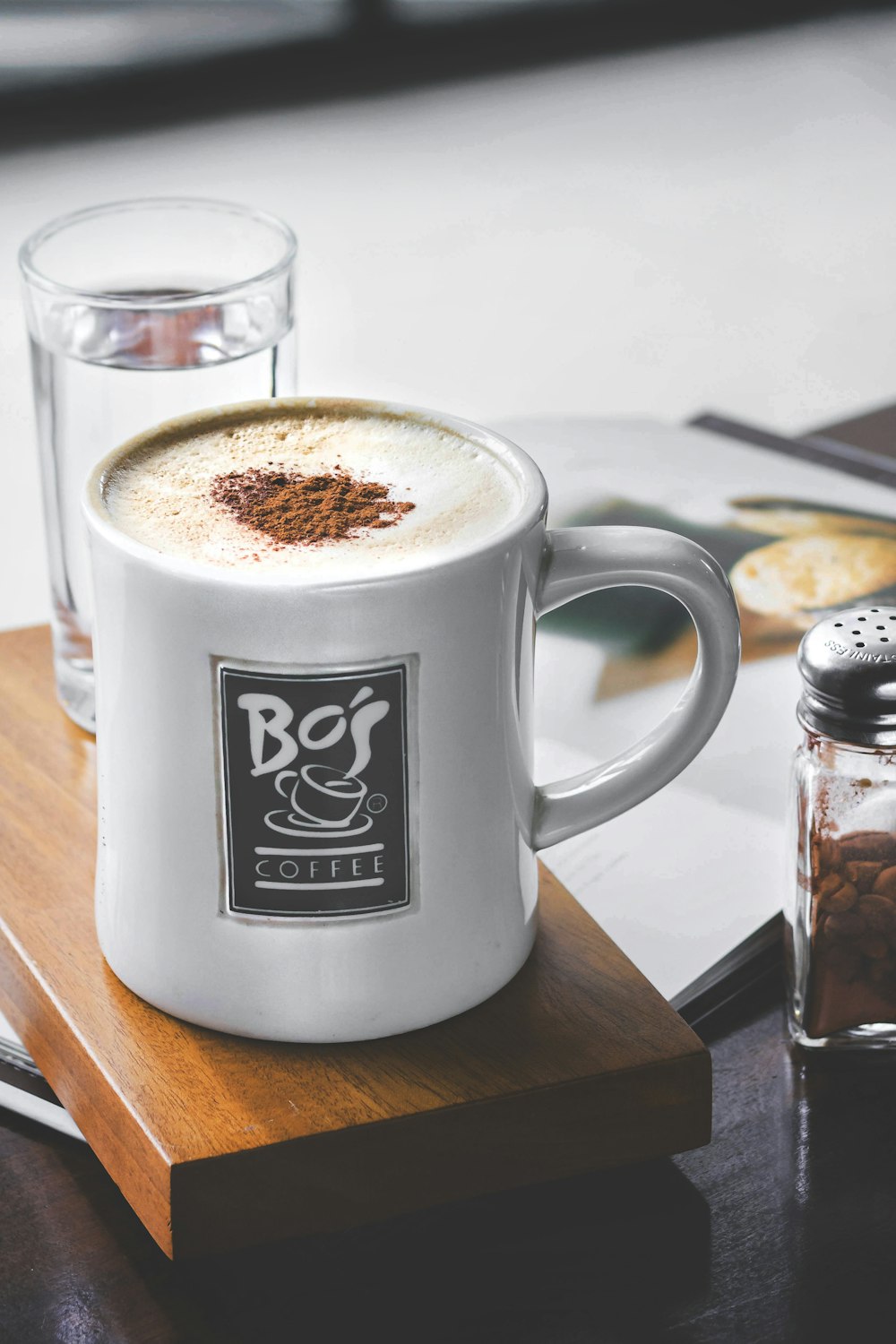 white and black Bo's mug filled with cappuccino