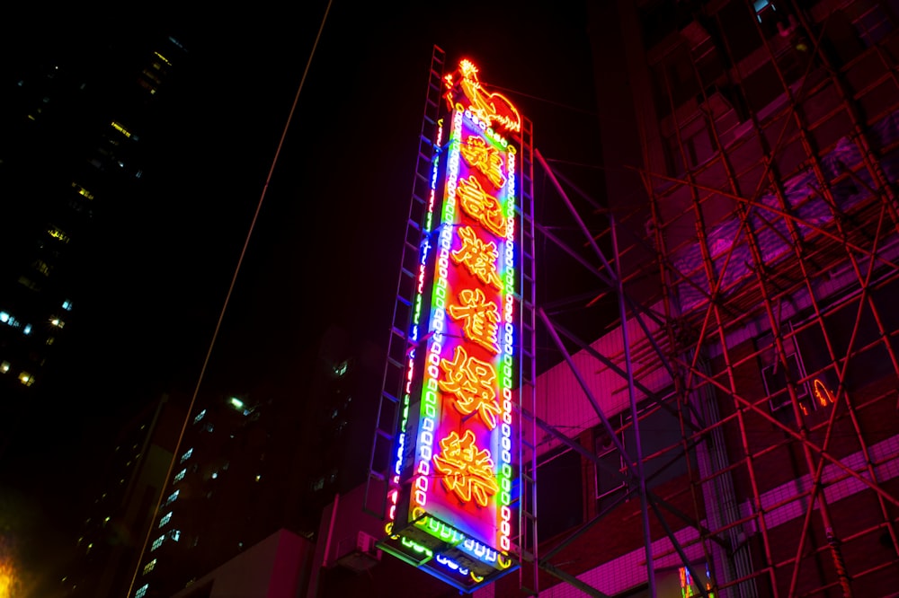 lighted green, red, and orange kanji signage during nighttime