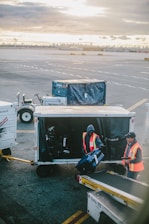 two men holding luggage on airport