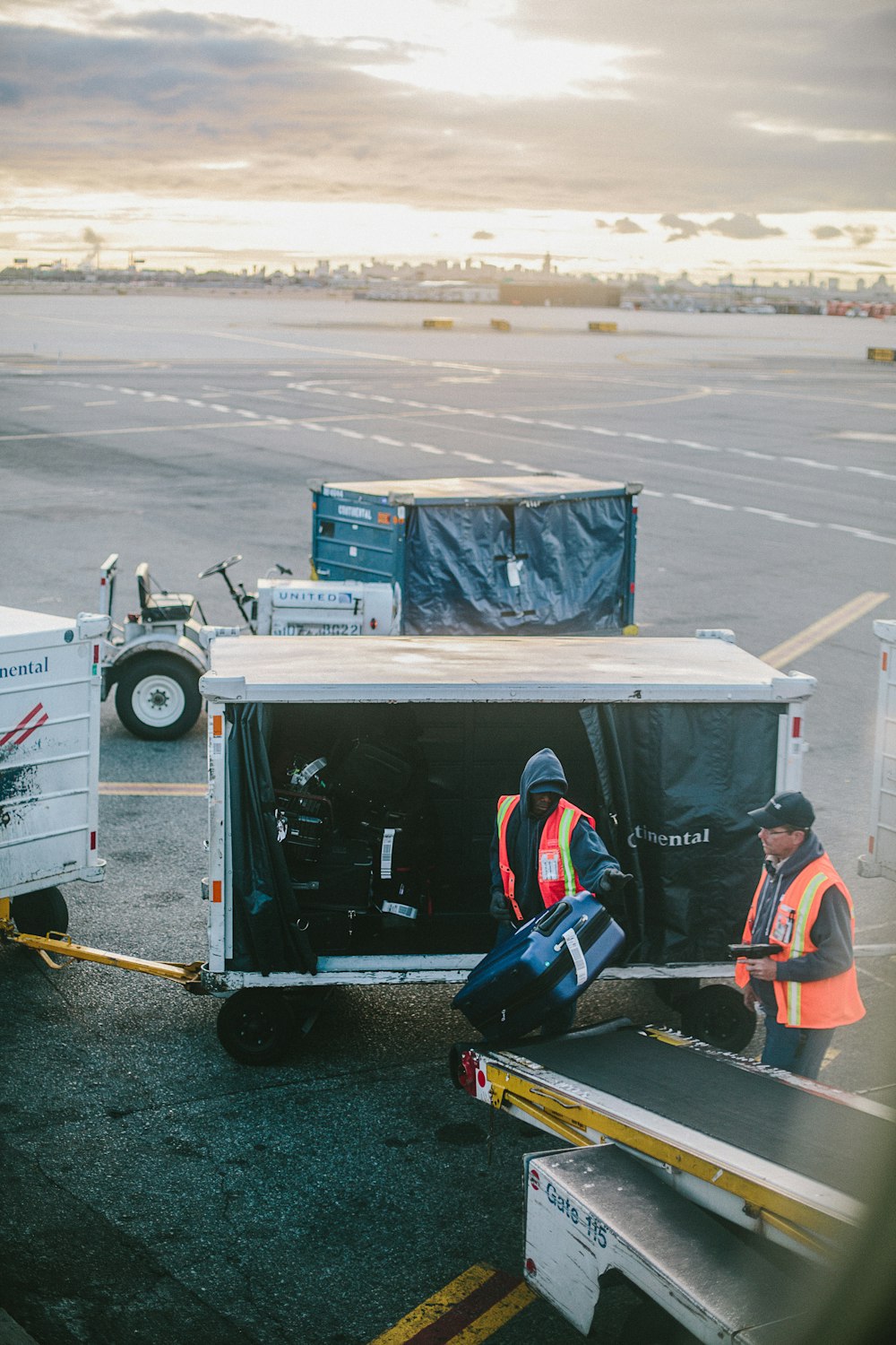 two men holding luggage on airport