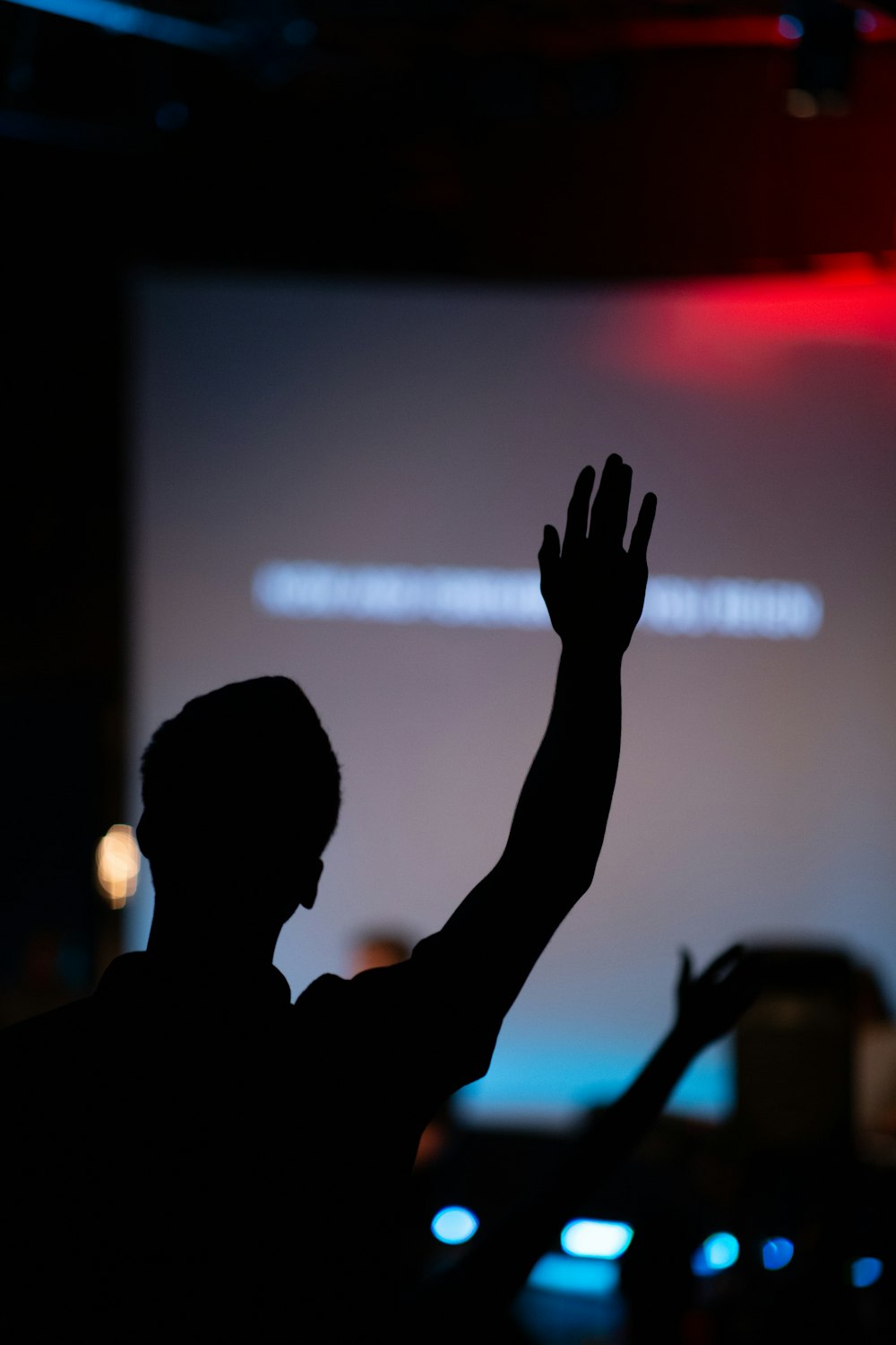 silhouette of person raising hand